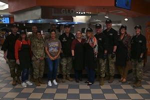 thanksgiving meals served by base leadership, leadership is all in black chef outfits serving base members