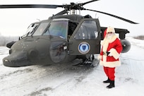 Santa Claus smiles after arriving in Circle, Alaska, on board an Alaska Army National Guard UH-60 Black Hawk to deliver gifts to children during Operation Santa Claus, Nov. 6, 2024. The Alaska National Guard's annual community outreach program has provided toys, backpacks and books to children in remote Alaskan communities since 1956.