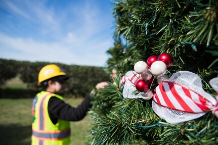 female employee decorating Christmas outdoors