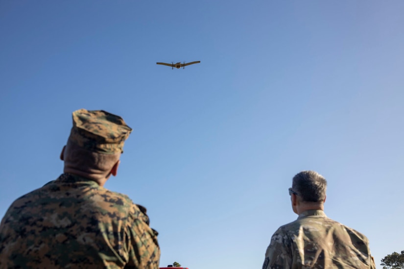 Service members observe an aircraft in flight.