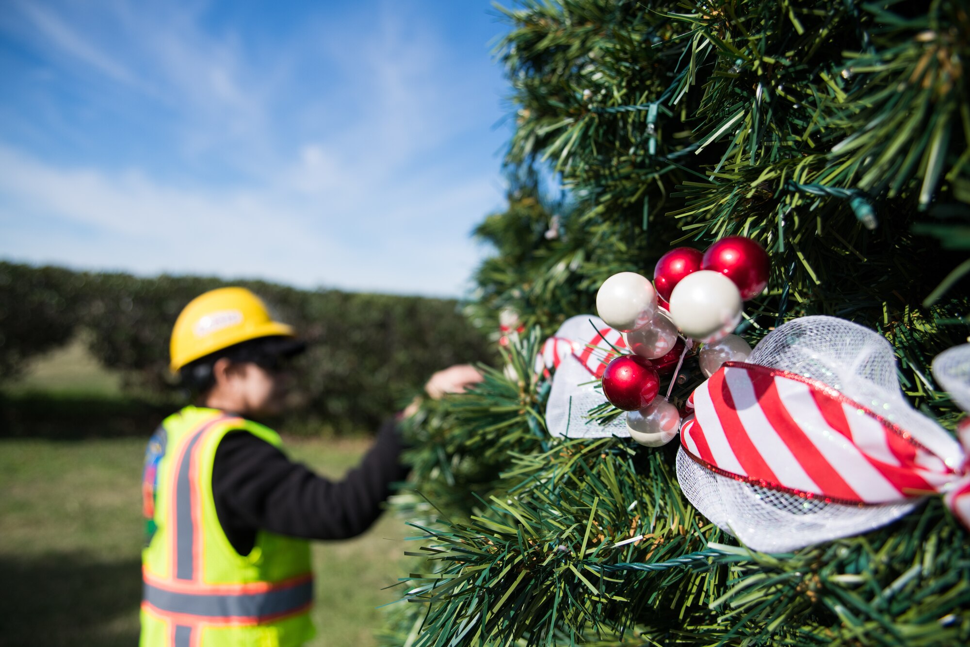 female employee decorating Christmas outdoors