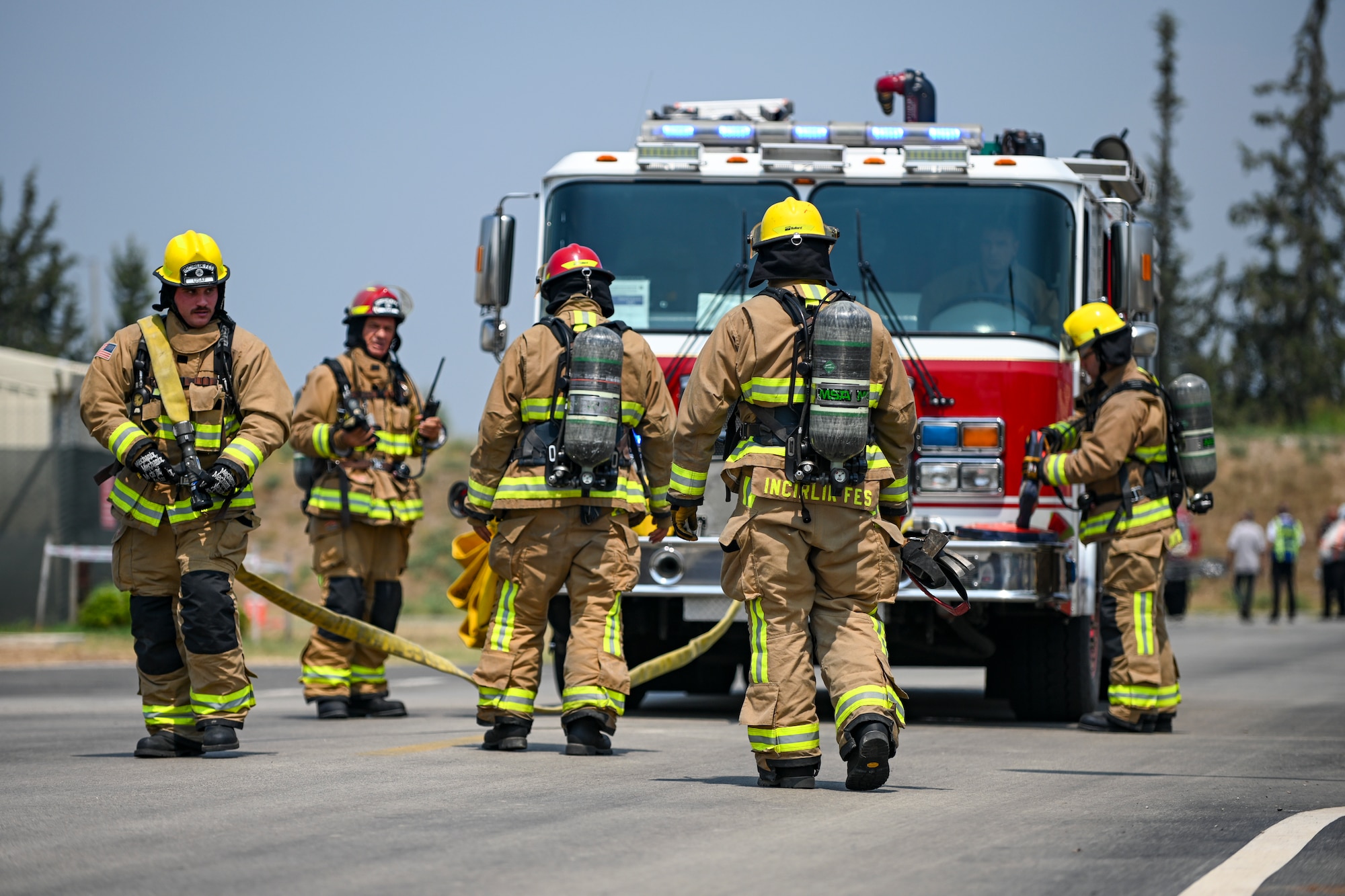 Firefighters assigned to the 39th Civil Engineer Squadron set up a cleansing area during a simulated energy oil spill response training scenario at Incirlik Air Base, Türkiye, July 25, 2024. This area served as a place to clean the simulated jet fuel off of anyone who had come into contact with it. (U.S. Air Force photo by Senior Airman Haiden Morris)