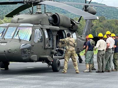 Tennessee National Guard Soldiers from Nashville’s 1-230th Assault Helicopter Battalion at the Elizabethton Municipal Airport prepare to transport Tennessee State Forestry personnel into areas affected by Hurricane Helene to begin debris removal Sept. 30, 2024.