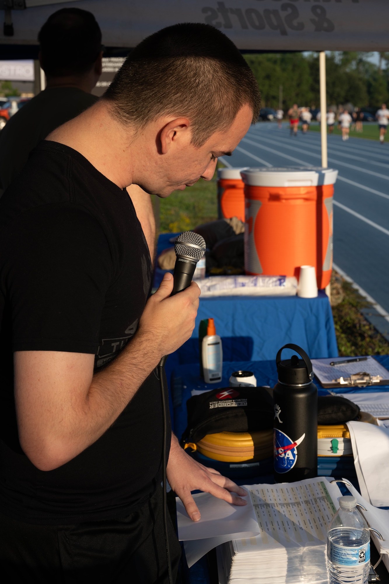 U.S. Air Force Senior Airman Anthony Mott, a 24th Special Operations Wing resource advisor, reads the names of prisoners of war and those missing in action during a 24-hour vigil run at the Aderholt Fitness Center track at Hurlburt Field, Florida, Sept. 19, 2024.