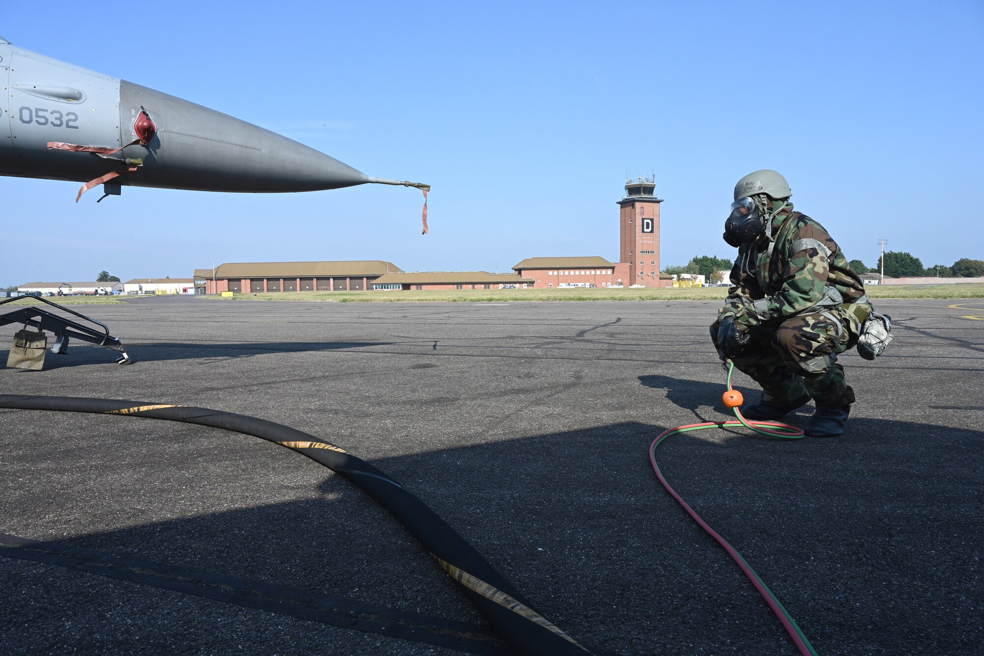 U.S. Air Force Senior Airman Jovon Green, 100th Logistics Readiness Squadron Petroleum, Oils and Lubricants flight fuels distribution technician, monitors fuel flow from an R-11 Refueler truck to an F-16 Fighting Falcon from Aviano Air Base, Italy, while wearing mission-oriented protective posture gear at Royal Air Force Mildenhall, England, Sept. 19, 2024.