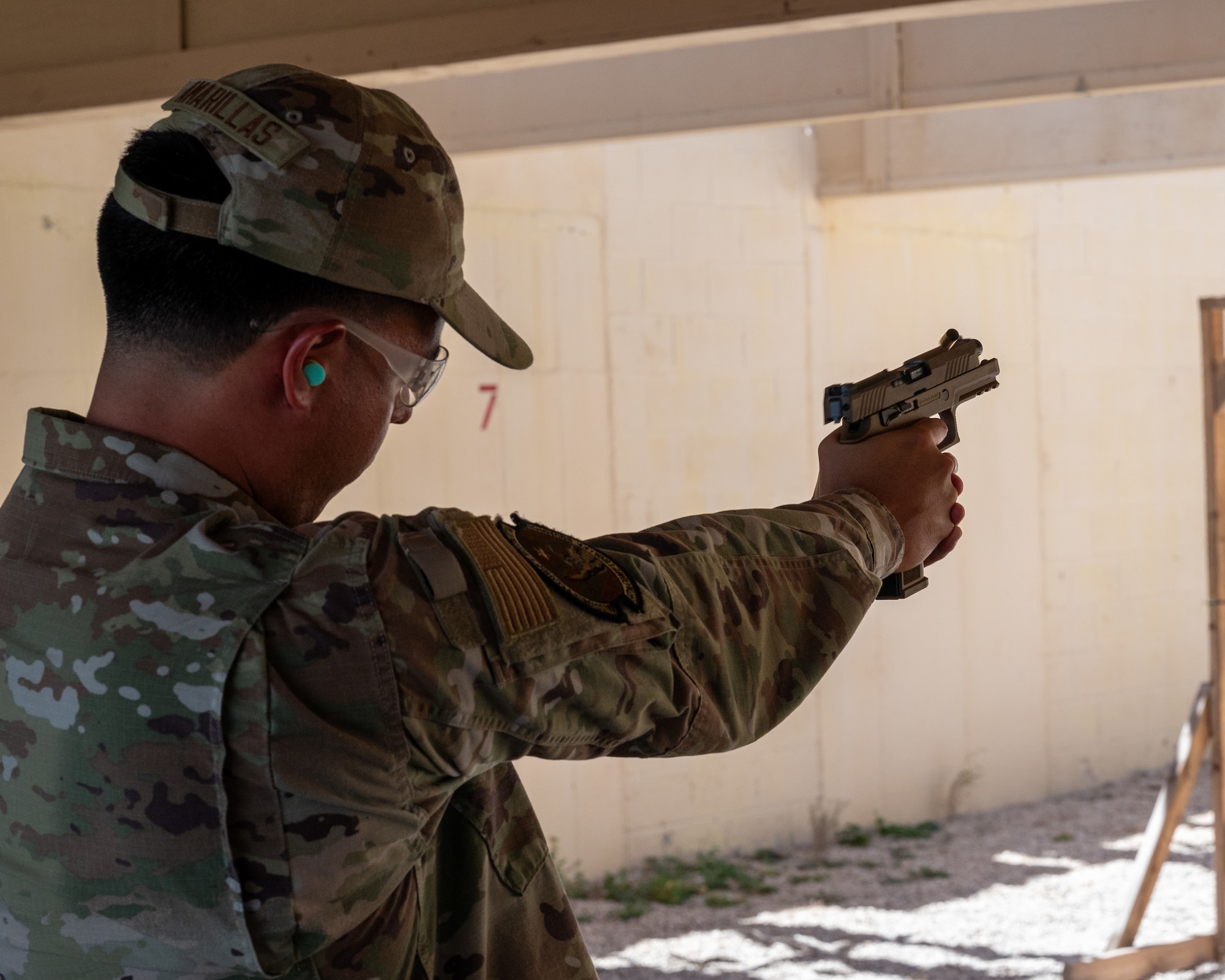 U.S. Air Force Airman 1st Class Daniel Amarillas, 47th Comptroller Squadron security forces augmentee, fires an M-18 pistol during qualifications at Laughlin Air Force Base, Texas, Aug. 21, 2024. During training, augmentees needed to qualify on the M-18 and the M-4, demonstrating thier competence with the firearms. (U.S. Air Force photo by Staff Sgt. Nicholas Larsen)