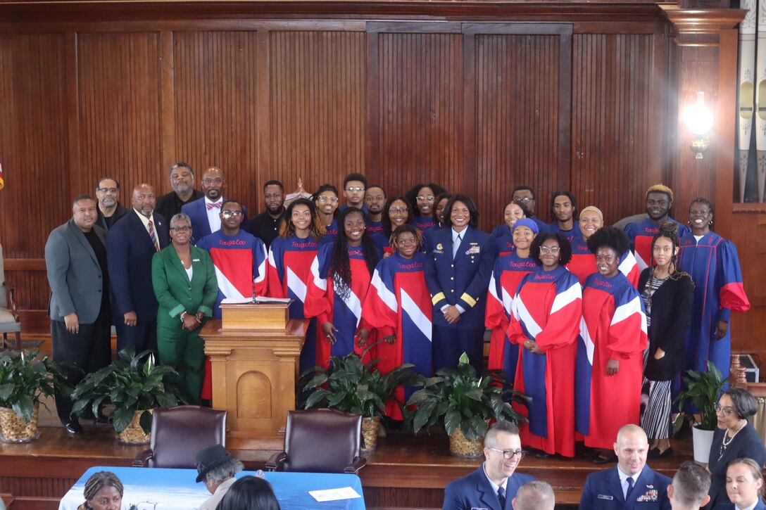 Coast Guard personnel and Tougaloo College staff and students stand together on stage during a ceremony Sept. 18, 2024, at Tougaloo College in Jackson, Mississippi. The Coast Guard announced a landmark Memorandum of Understanding (MOU) with Tougaloo College. (Photo courtesy of Tougaloo College)