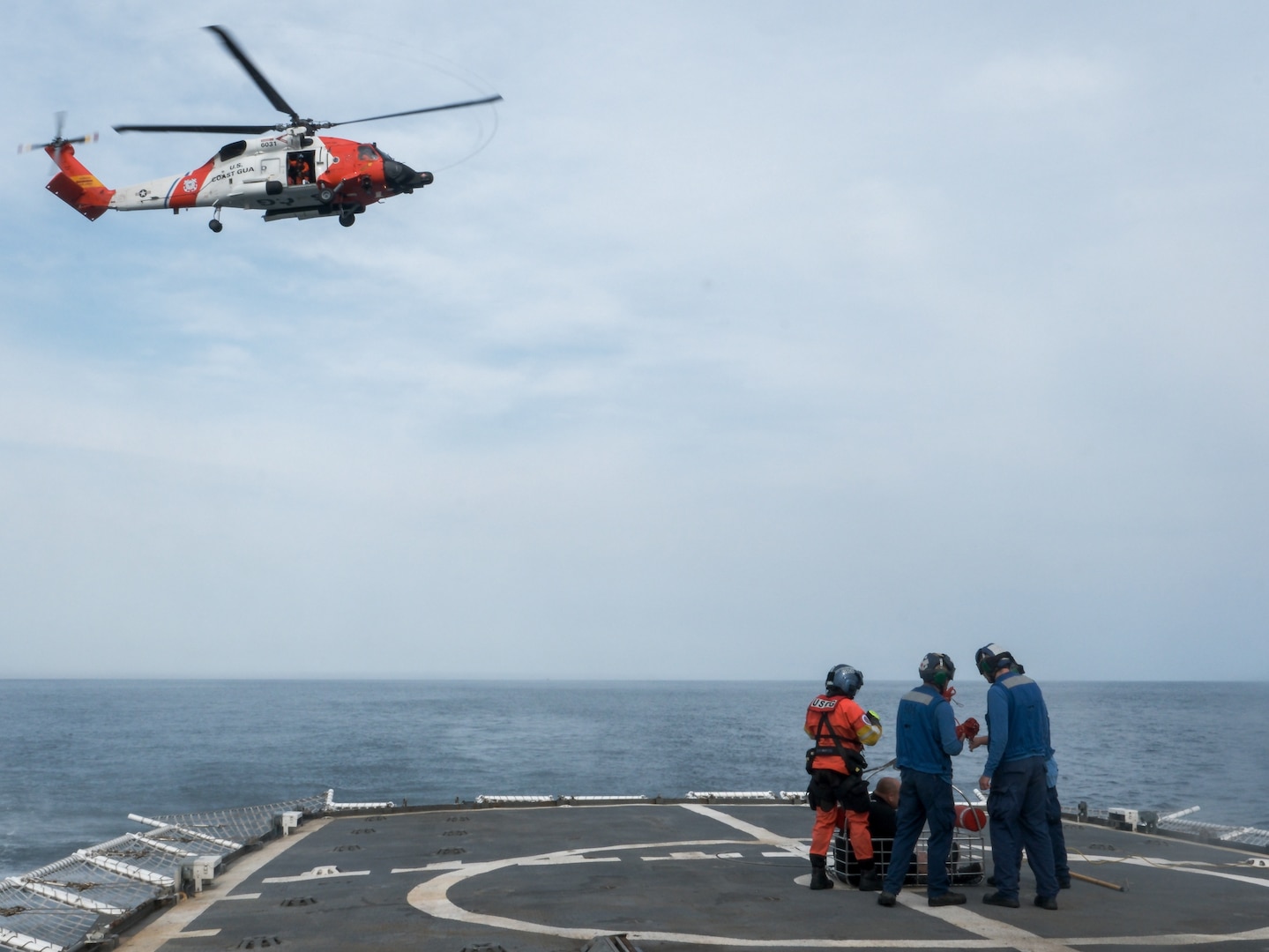 Coast Guard Cutter Northland (WMEC 904) crew members and an Air Station Cape Cod MH-60 Jayhawk helicopter aircrew conduct a medevac of an injured fisherman, Sept. 18, 2024, while underway in the Atlantic Ocean. The Coast Guard transported the fisherman to a higher level of care. (U.S. Coast Guard photo by Petty Officer 3rd Class Anthony Randisi)