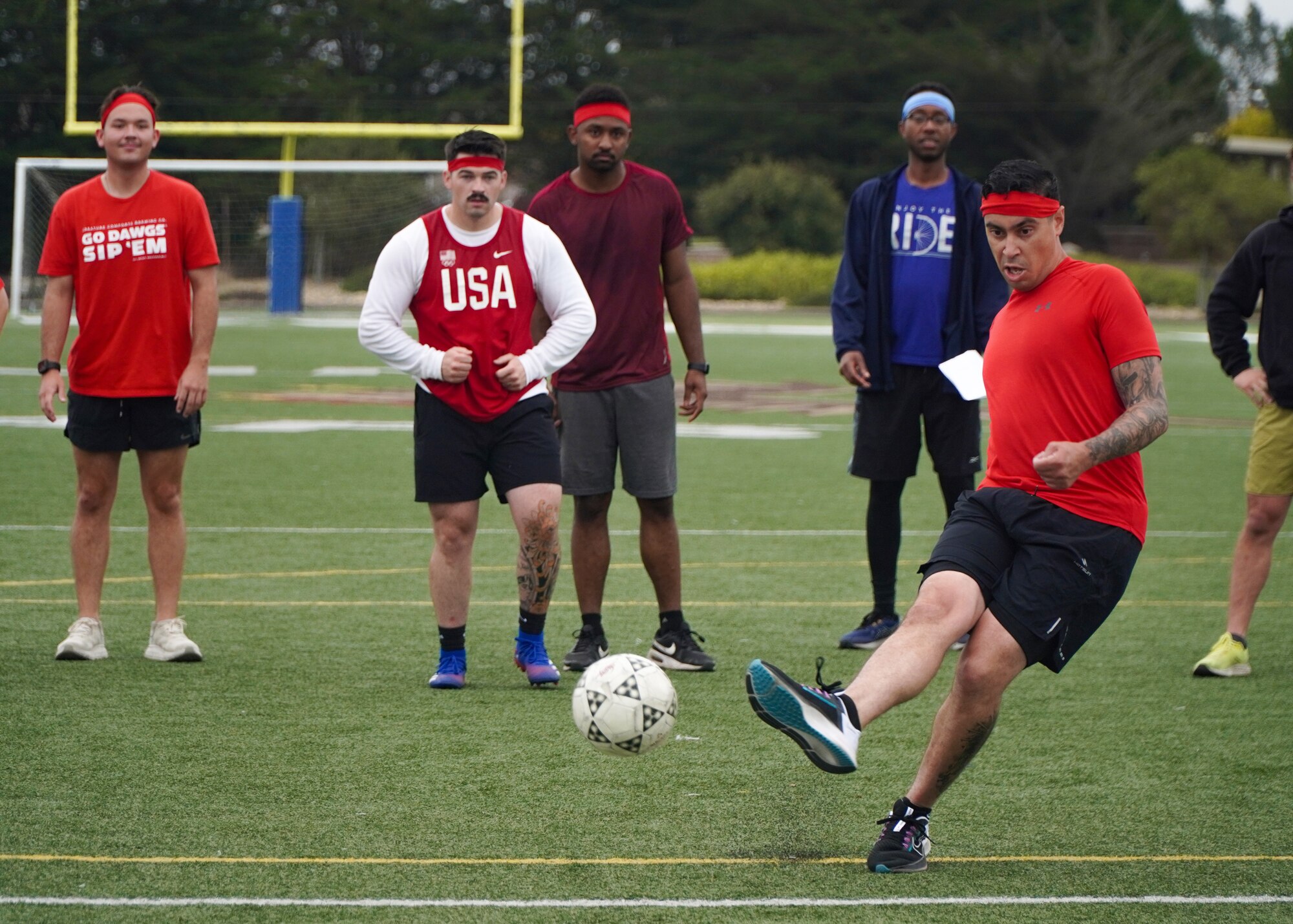 Members of the 30th Logistics Readiness Squadron look on as one of their teammates takes a penalty kick during a soccer game at Vandenberg Space Force Base, Calif., Sept. 26, 2024. 30 LRS held a morale day full of sports events, including basketball, soccer, and ultimate frisbee. (U.S. Space Force photo by Senior Airman Ryan Quijas)