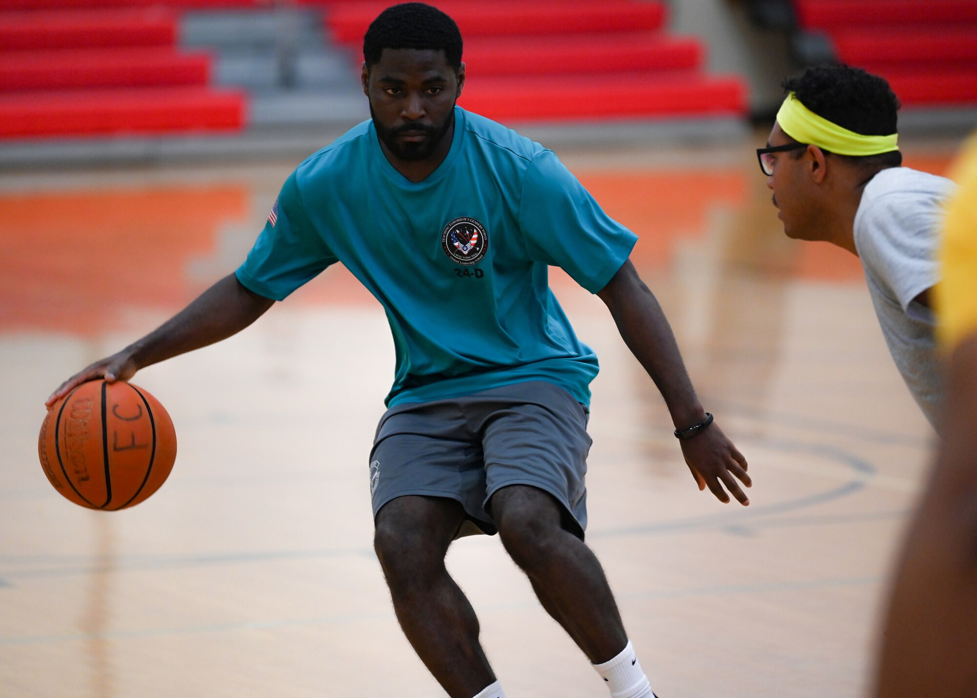 Senior Airman Devreountre Buchanan, 30th Logistics Readiness Squadron ground transportation dispatcher, dribbles a basketball toward his opponent during a 30 LRS sports day event at Vandenberg Space Force Base, Calif., Sept. 26, 2024. The squadron held a morale day full of sports events, including basketball, soccer, and ultimate frisbee. (U.S. Space Force photo by Senior Airman Ryan Quijas)
