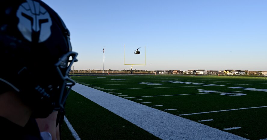 A UH-1 Iroquois assigned to the 54th Helicopter Squadron prepares to land at Sentinel Stadium after the National Anthem of a Minot North High School football game, Minot, North Dakota, Sept. 27, 2024. As part of the pre-game ceremonies the 54th HS performed a fly-over and delivered 91st Missile Wing leadership to give the game ball to officials at the start of the game. (U.S. Air Force photo by Tech. Sgt. Rusty Frank)