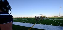 91st Missile Wing leadership walk on the field at Sentinel Stadium prior to the start of a Minot North High School football game at Minot, North Dakota, Sept. 27, 2024. The 91st MW delivered the game ball to kick-off the first homecoming game of Minot North High School. (U.S. Air Force photo by Tech. Sgt. Rusty Frank)