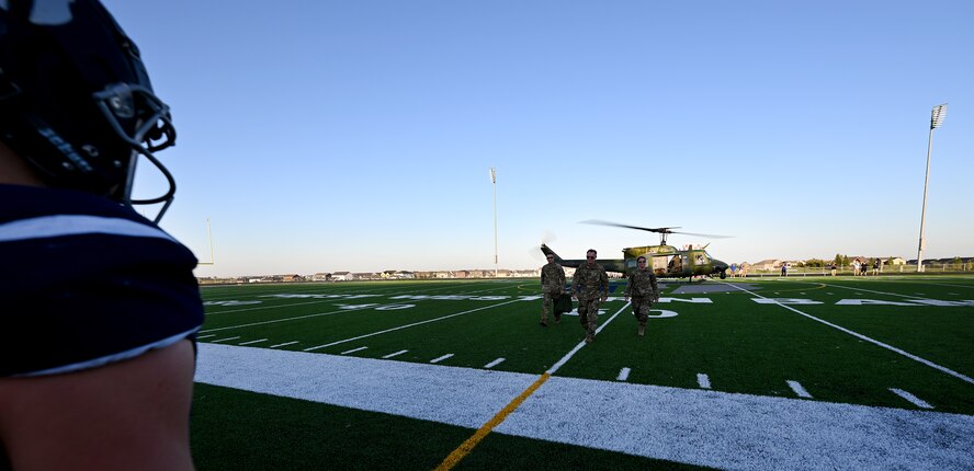 91st Missile Wing leadership walk on the field at Sentinel Stadium prior to the start of a Minot North High School football game at Minot, North Dakota, Sept. 27, 2024. The 91st MW delivered the game ball to kick-off the first homecoming game of Minot North High School. (U.S. Air Force photo by Tech. Sgt. Rusty Frank)