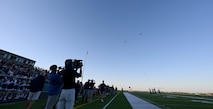 Two UH-1 Iroquois assigned to the 54th Helicopter Squadron perform a fly-over at Sentinel Stadium during the National Anthem of a Minot North High School football game at Minot, North Dakota, Sept. 27, 2024. As part of the pre-game ceremonies the 54th HS performed a fly-over and delivered 91st Missile Wing leadership to give the game ball to officials at the start of the game. (U.S. Air Force photo by Tech. Sgt. Rusty Frank)