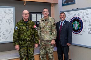 Three men pose for group photo