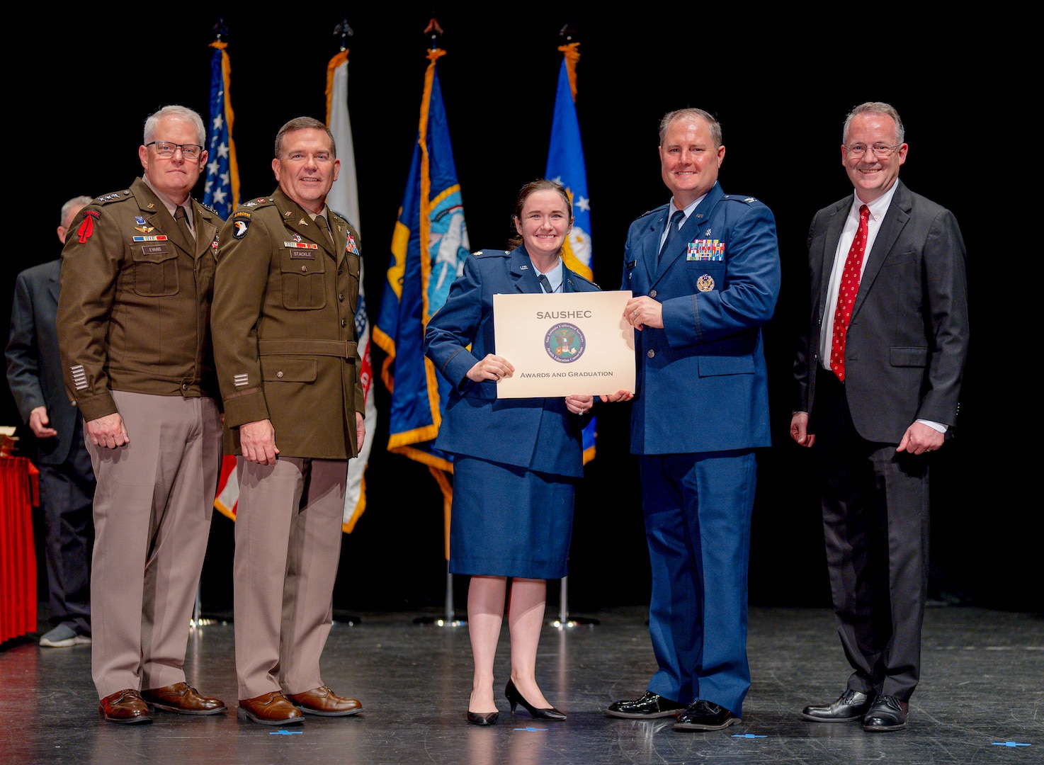 U.S. Air Force Col. Wade Adair, deputy commander of the 59th Medical Wing, presents Maj. Lauren Gabreski, an allergist and immunologist with the 48th Healthcare Operations Squadron, with a certificate of completion from the Allergy and Immunology Fellowship at the Henry B. González Convention Center in San Antonio on June 7, 2024. Gabreski, who recently completed the fellowship, is eager to apply her expertise in her new overseas role while upholding the values of perseverance and service instilled by her family. (U.S. Air Force courtesy photo)