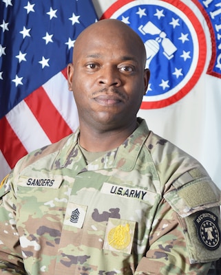 Army Recruiting Soldier in front of United States and USAREC flags