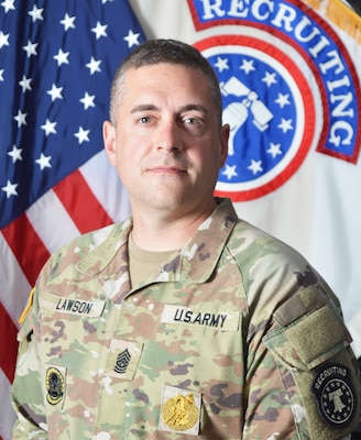 Army Soldier in front of U.S. and Army Recruiting flags