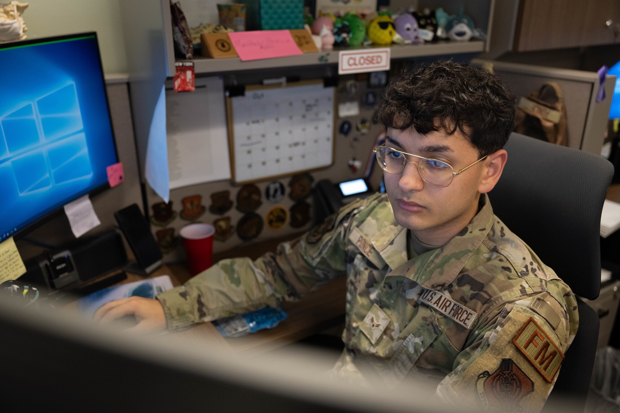 A finance Airman works on a desktop.