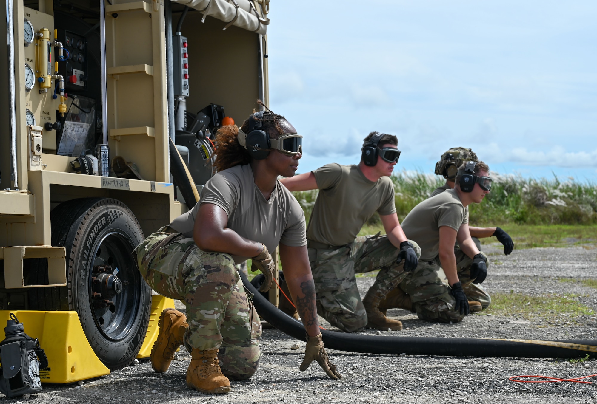 Airmen from the 36th Logistics Readiness Squadron observe a U.S. Navy HSC-25 helicopter to take off at the Pacific Regional Training Center – Andersen Air Force Base, Guam on Sept. 24, 2024. The Airmen were engaged in hot-pit refueling via a STARCART. (U.S. Air Force photo by Airman 1st Class Natasha Ninete)