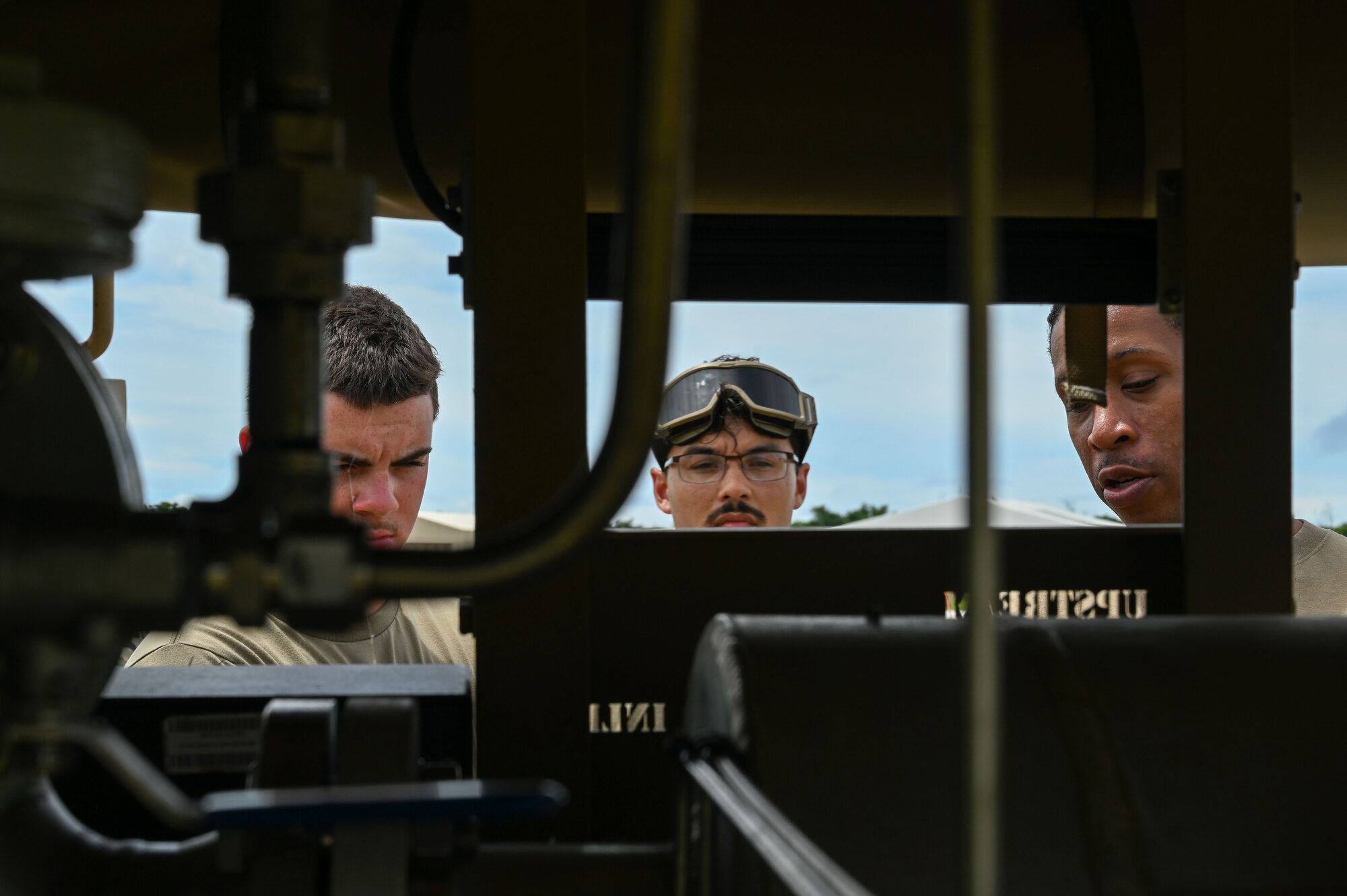 From left, Airman Caden DeGroat, Airman 1st Class Aiden Rodriguez, 36th Logistics Readiness Squadron fuels distribution operators, and Tech. Sgt. Clarence Graves, 36th LRS superintendent, look at a STARCART at the Pacific Regional Training Center – Andersen Air Force Base, Guam on Sept. 24, 2024. The 36th LRS worked with the 36th Contingency Response Squadron to familiarize some of the squadron’s newest Airmen on hot-pit refueling. (U.S. Air Force photo by Airman 1st Class Natasha Ninete)