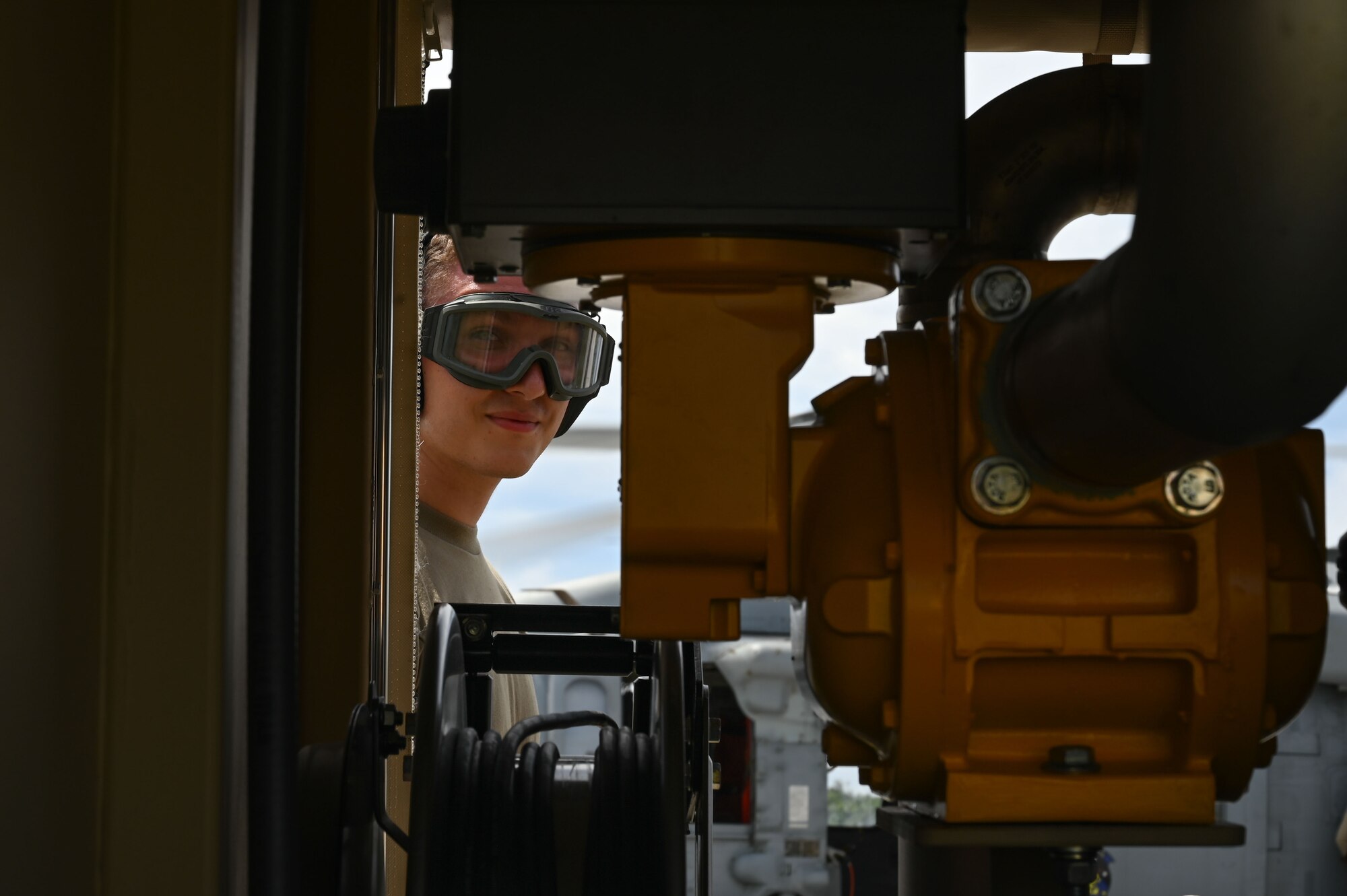 Airman Brayden Costley, 36th Logistics Readiness Squadron fuels distribution operator, peers through a STARCART at the Pacific Regional Training Center – Andersen Air Force Base, Guam on Sept. 24, 2024. Costley learned how to operate a STARCART used for hot-pit refueling from specialists with the 36th Contingency Response Squadron. (U.S. Air Force photo by Airman 1st Class Natasha Ninete)