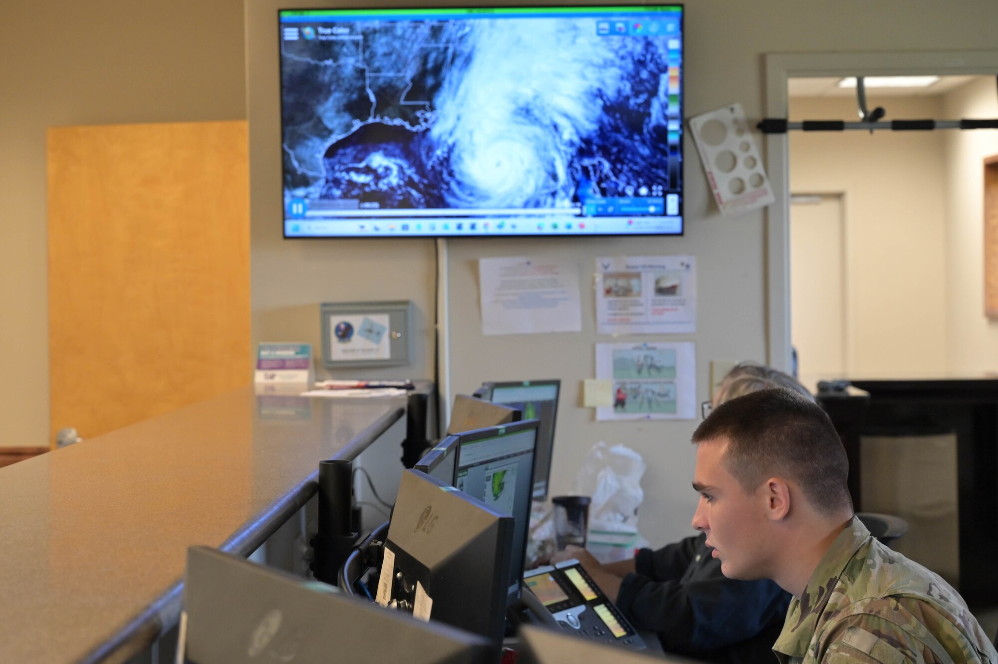 Airman Kyle Cummings analyzes weather patterns