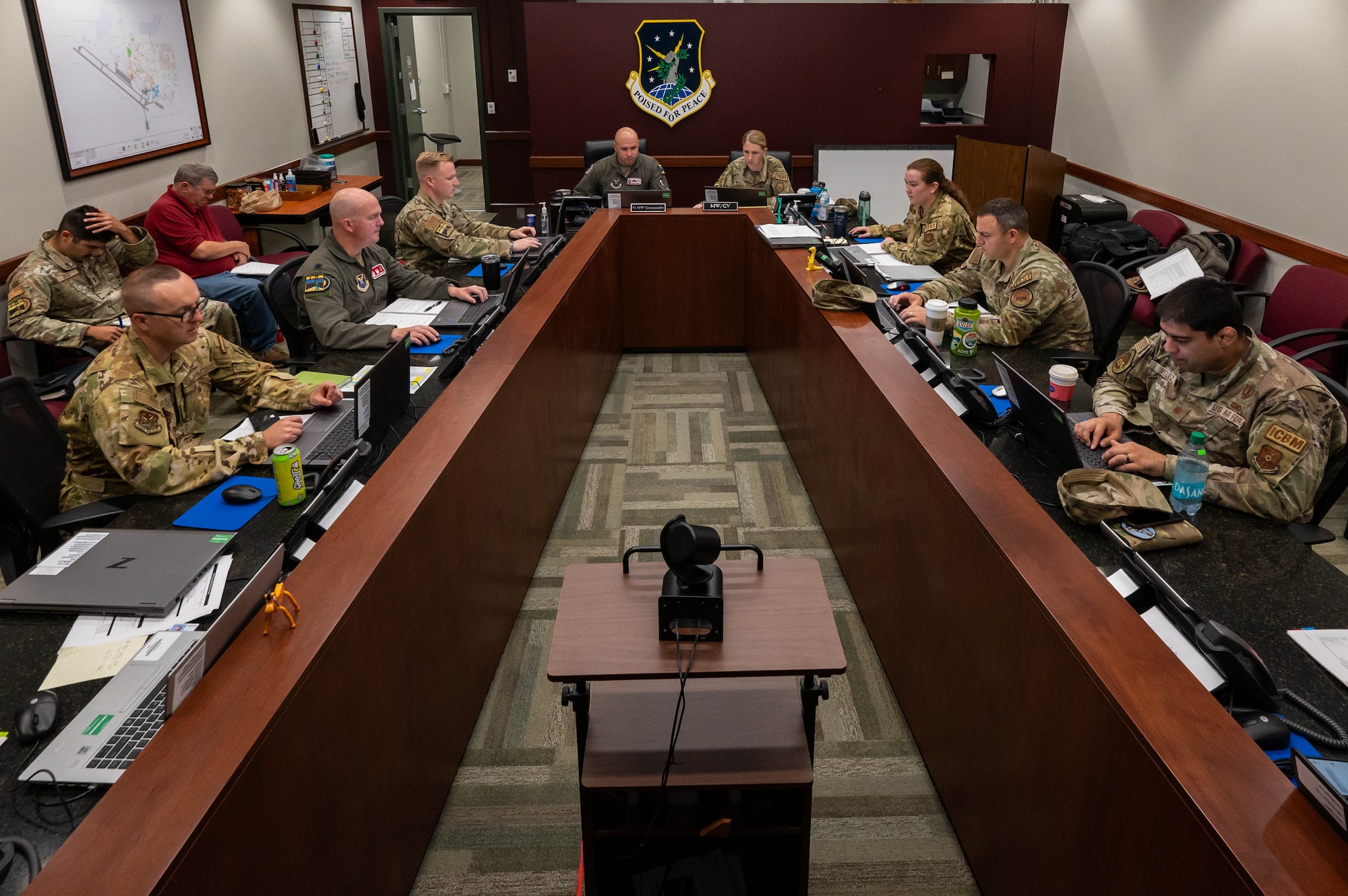 Members of Minot Air Force base’s 91st Missile Wing and Vandenberg Space Force Base’s 576th Flight Test Squadron, coordinate with other agencies during the simulated electronic launch of a Minuteman III (SELM) at Minot Air Force Base, North Dakota, Sept. 17, 2024. The teams tested their ability as combat crews to launch from not only the launch control center (LCC) but from an airborne launch control system aboard a Navy E-6B Mercury aircraft, which is capable of remotely launching the fleet of MMIII ICBMs. (U.S. Air Force photo by Senior Airman Alexander)