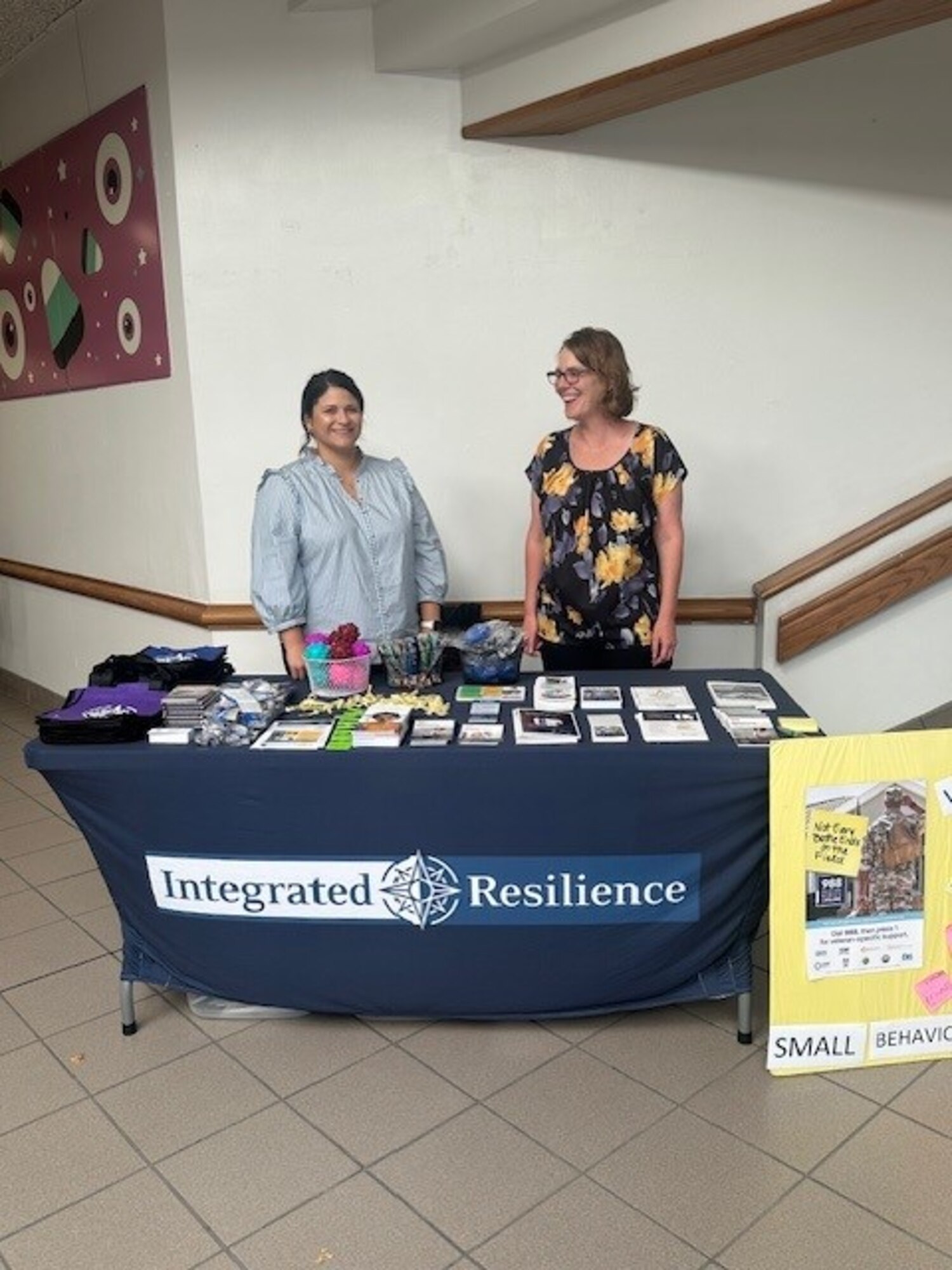 Two people stand at a booth