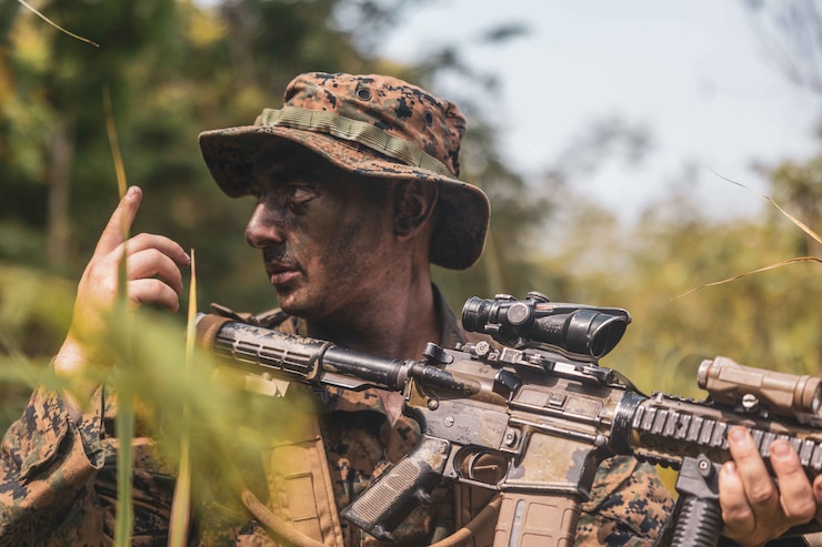 U.S. Marine Corps Cpl. David Schatz, a mortarman with 1st Battalion, 7th Marine Regiment, attached to Marine Rotational Force-Southeast Asia, sets security on a patrol during Keris Marine Exercise 2023 as part of MRF-SEA, at Piabung Training Area in Sukabumi, West Java, Indonesia, Dec. 6, 2023. MRF-SEA is a Marine Corps Forces Pacific operational model that involves exchanges with subject matter experts, promotes security goals with Allies and partners, and positions I MEF forces west of the International Date Line. (U.S. Marine Corps photo by Cpl. Dean Gurule)