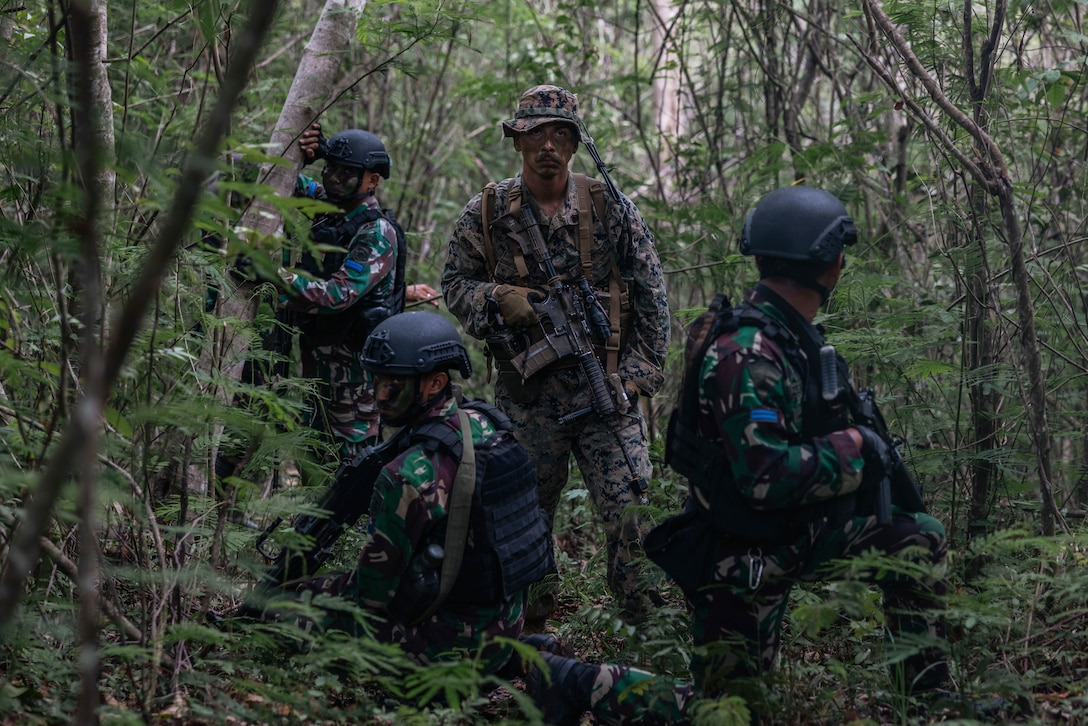 U.S. Marine Corps Sgt. Ricardo Rivera, a platoon sergeant with 1st Battalion, 7th Marine Regiment, attached to Marine Rotational Force-Southeast Asia and Indonesian marines with 4th Marine Infantry Battalion, Pasmar 1, conduct tactical operations during Keris Marine Exercise 2023 at Piabung Training Area in Sukabumi, West Java, Indonesia, Dec. 1, 2023. Keris MAREX is a bilateral exercise led by the U.S. Marine Corps and the Indonesian Marine Corps, or Korps Marinir, to promote military interoperability and maritime domain awareness capabilities, strengthen relationships, and expand military capabilities among participating forces in the advancement of a Free and Open Indo-Pacific. MRF-SEA is a Marine Corps Forces Pacific operational model that involves exchanges with subject matter experts, promotes security goals with Allies and partners, and positions I MEF forces west of the International Date Line. (U.S. Marine Corps photo by Sgt. Shaina Jupiter)