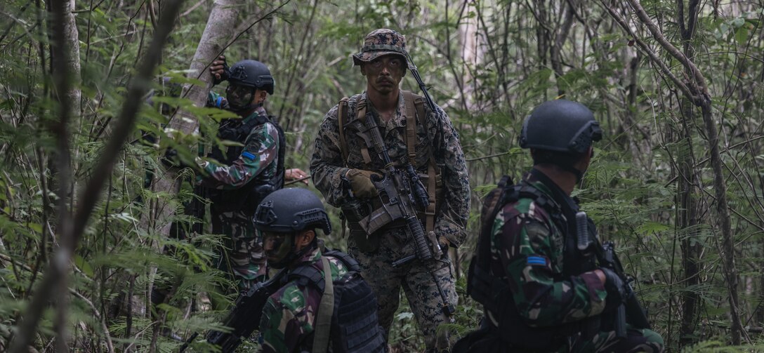 U.S. Marine Corps Sgt. Ricardo Rivera, a platoon sergeant with 1st Battalion, 7th Marine Regiment, attached to Marine Rotational Force-Southeast Asia and Indonesian marines with 4th Marine Infantry Battalion, Pasmar 1, conduct tactical operations during Keris Marine Exercise 2023 at Piabung Training Area in Sukabumi, West Java, Indonesia, Dec. 1, 2023. Keris MAREX is a bilateral exercise led by the U.S. Marine Corps and the Indonesian Marine Corps, or Korps Marinir, to promote military interoperability and maritime domain awareness capabilities, strengthen relationships, and expand military capabilities among participating forces in the advancement of a Free and Open Indo-Pacific. MRF-SEA is a Marine Corps Forces Pacific operational model that involves exchanges with subject matter experts, promotes security goals with Allies and partners, and positions I MEF forces west of the International Date Line. (U.S. Marine Corps photo by Sgt. Shaina Jupiter)