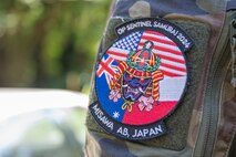An Operation Sentinel Samurai exercise patch shows the flags of participating nations.