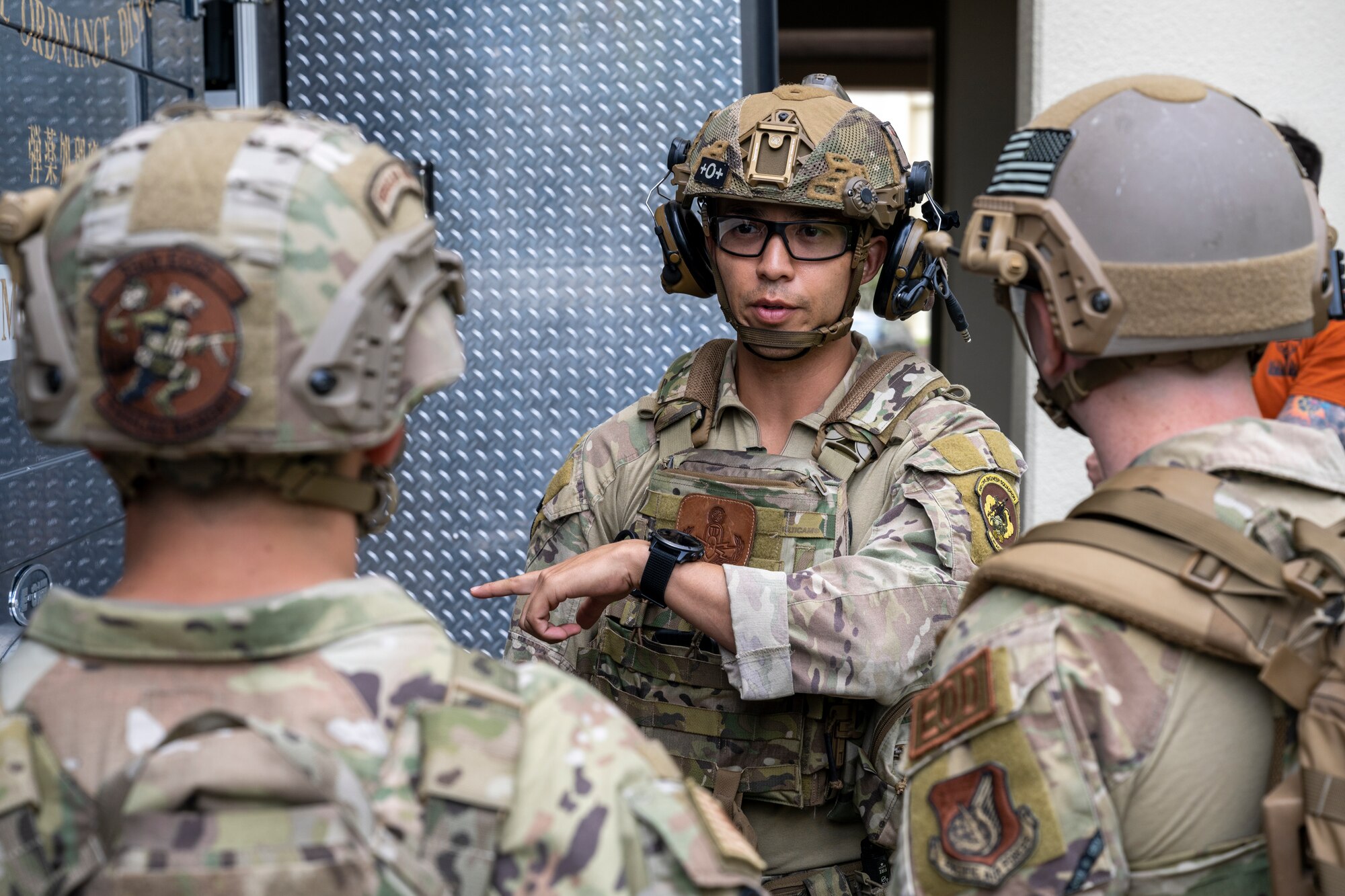 U.S. Air Force Staff Sgt. Sho Kasahara, 35th Civil Engineer Squadron explosive ordnance disposal (EOD) technician, gives instructions to his team before engaging in an explosive vest scenario.
