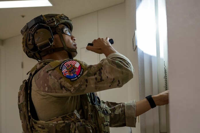 U.S. Air Force Staff Sgt. Sho Kasahara, 35th Civil Engineer Squadron explosive ordnance disposal (EOD) technician, checks a door for booby-traps.