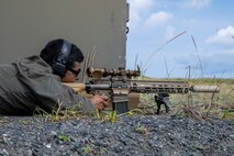 U.S. Marine Corps Staff Sgt. Cesar Martinez, explosive ordnance disposal response element leader with Headquarters and Headquarters Squadron, Marine Corps Air Station Iwakuni, fires an M110 Semi-Automatic Sniper System at simulated munitions.