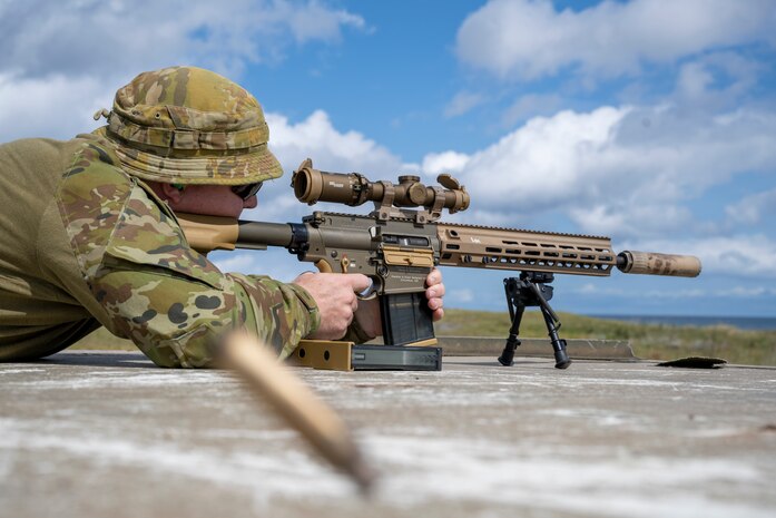 Royal Australian Air Force Flight Sgt. Tristan Crump, explosive ordnance disposal (EOD) observer, fires an M110 Semi-Automatic Sniper System.