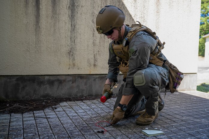 U.S. Marine Corps Sgt. Riley Hummell, explosive ordnance disposal technician with Headquarters and Headquarters Squadron, Marine Corps Air Station Iwakuni, clears out a booby-trapped house.