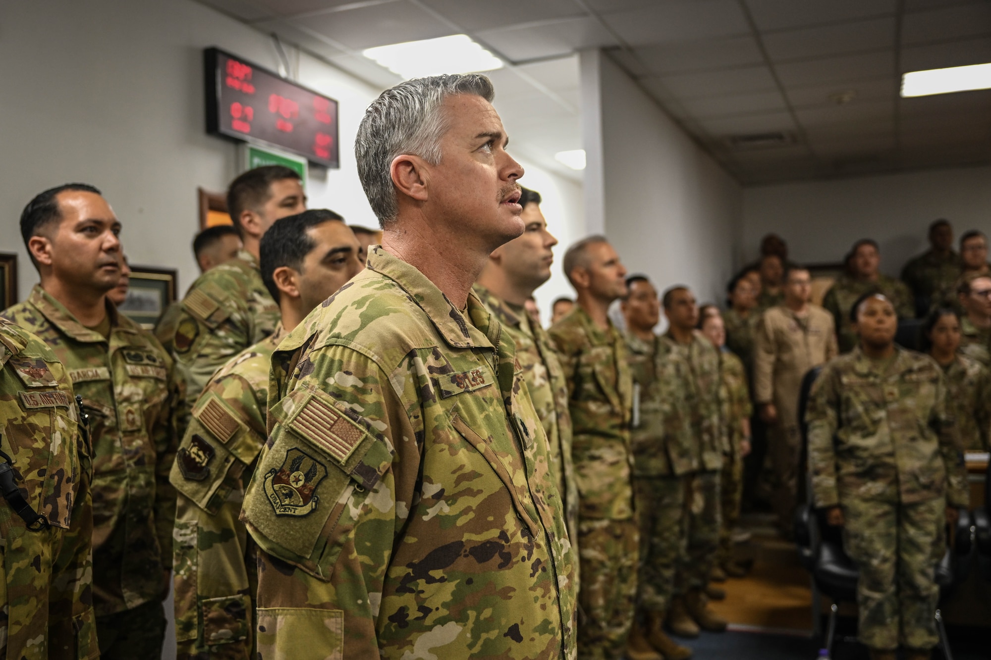 Airmen sing the Air Force song during a ceremony.