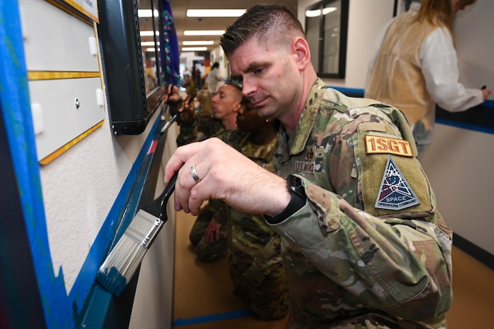 Service members collaborate with military spouses