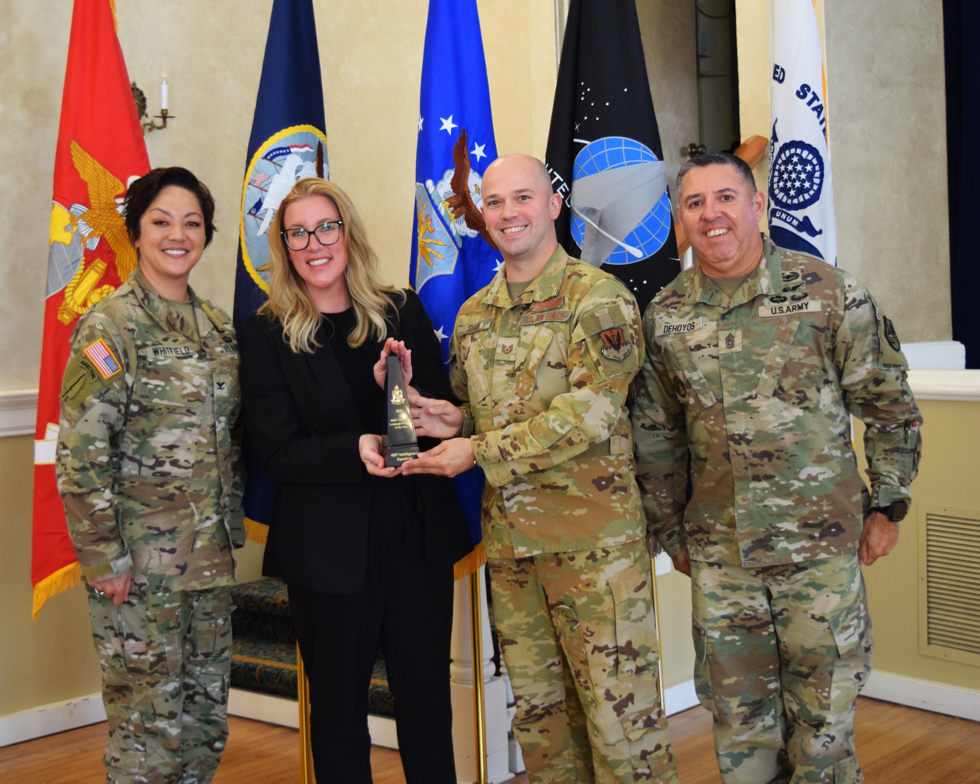 Military members and a DOD Civilian pose for a photo