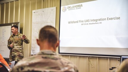 Col. Shane Riley, director of Military Support, Oklahoma National Guard, briefs local partners during a multi-agency wildland firefighting unmanned aerial systems integration exercise at Crowder Lake near Weatherford, Oklahoma, Sept. 25-26. The exercise brought the Oklahoma National Guard, state and local agencies and several private UAS companies together to develop a common operating picture, ensuring all public safety teams have a shared view of a multi-agency response to events like wildland firefighting. (Oklahoma National Guard photo by Staff Sgt. Reece Heck)