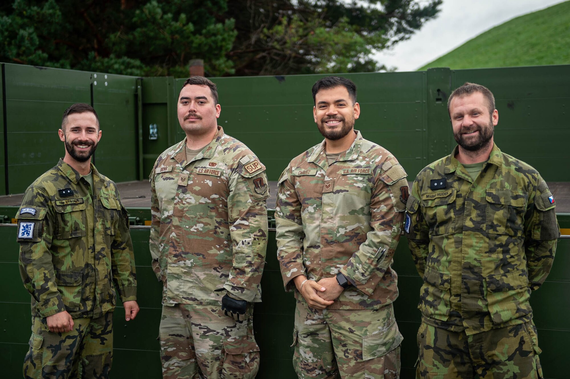 Two U.S. Air Force Airmen pose for a photo in the middle of two Czech Air Force service members
