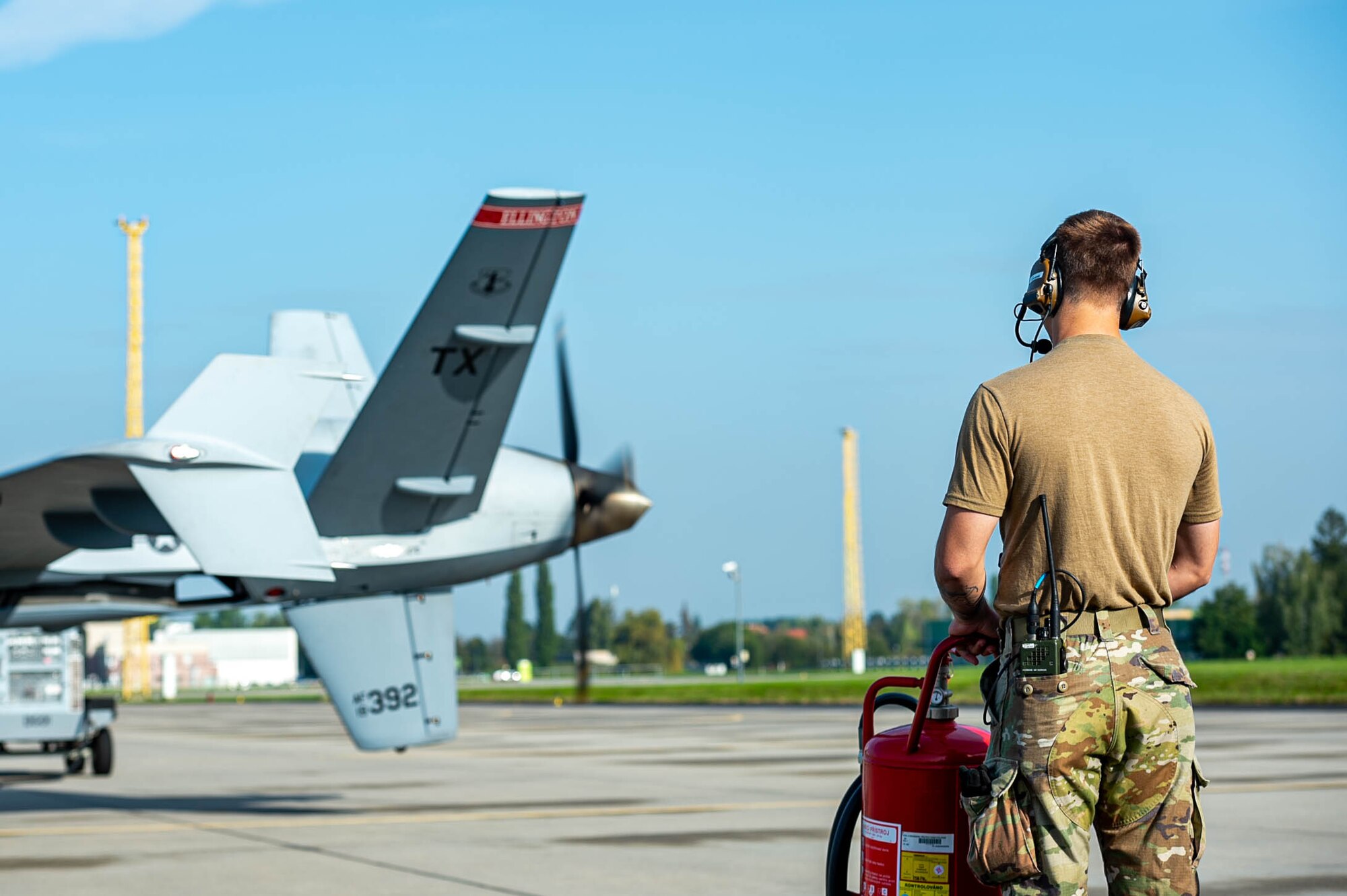 A U.S. crew chief from the 147th Attack Wing conducts pre-flight checks of an MQ-9 Reaper aircraft.