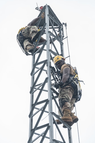 Airmen climbing up tower