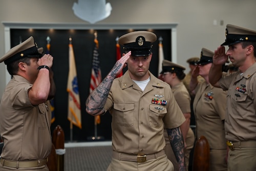 U.S. Navy Aviation Boatmate’s Aircraft Handler Chief Petty Officer Aaron Stevens, Navy Air Technical Training Center Pensacola Learning Site Goodfellow fire instructor, returns the salute of his fellow chief petty officers while being piped into the “Chief’s Mess” during the Fiscal Year 2025 CPO Pinning Ceremony at the Powell Event Center, Goodfellow Air Force Base, Texas, Sept. 27, 2024. Stevens joined the Navy in April 2010, after 14 years in the Navy he was selected for the rank of Chief Petty Officer. (U.S. Air Force photo by Airman 1st Class Evelyn J. D’Errico)