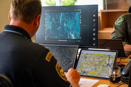 A Czech emergency services official reviews aerial footage captured by a Texas Air National Guard MQ-9 Reaper during flood relief operations at Čáslav Air Base, Czechia, Sept. 17, 2024. The footage is being used to coordinate response efforts and prioritize areas most affected by the flooding.