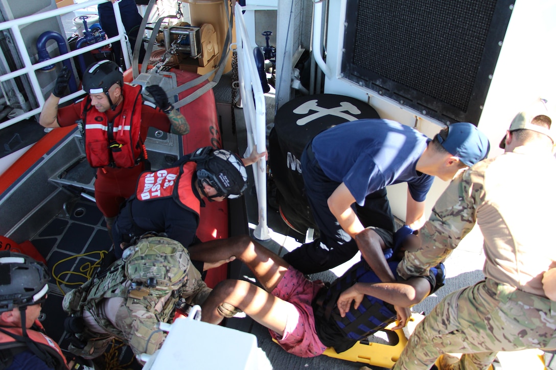 The crew of Coast Guard Cutter Joseph Tezanos rescues 14 migrants, Sept. 29, 2024, who were left stranded by smugglers on the uninhabited natural reserve of Monito Island, Puerto Rico, in the Mona Passage. The rescue involved efforts and coordination with Caribbean Border Interagency Group (CBIG) partner agencies and Puerto Rico Department of Natural and Environmental Resources Park Rangers.  The migrant group was transferred to U.S. Boder Patrol Agents in Mayaguez, Puerto Rico, where EMS authorities provided assistance. (U.S. Coast Guard photo)