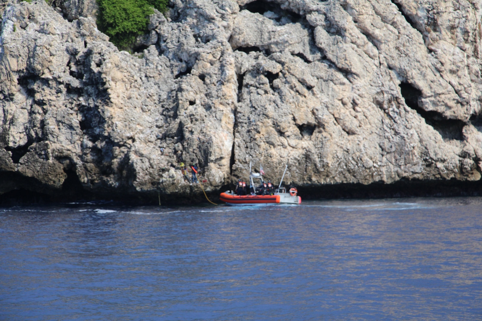 The crew of Coast Guard Cutter Joseph Tezanos rescues 14 migrants, Sept. 29, 2024, who were left stranded by smugglers on the uninhabited natural reserve of Monito Island, Puerto Rico, in the Mona Passage. The rescue involved efforts and coordination with Caribbean Border Interagency Group (CBIG) partner agencies and Puerto Rico Department of Natural and Environmental Resources Park Rangers.  The migrant group was transferred to U.S. Boder Patrol Agents in Mayaguez, Puerto Rico, where EMS authorities provided assistance. (U.S. Coast Guard photo)