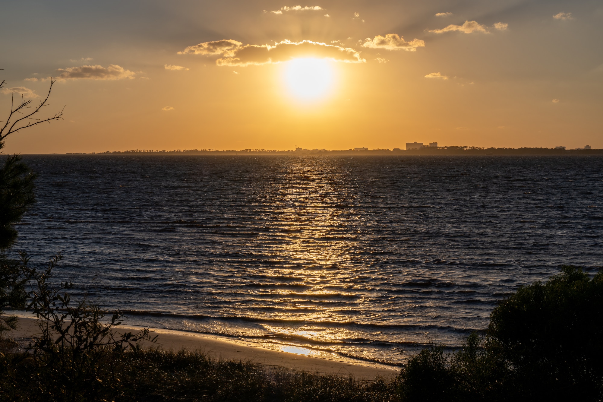 The sun sets over a bay